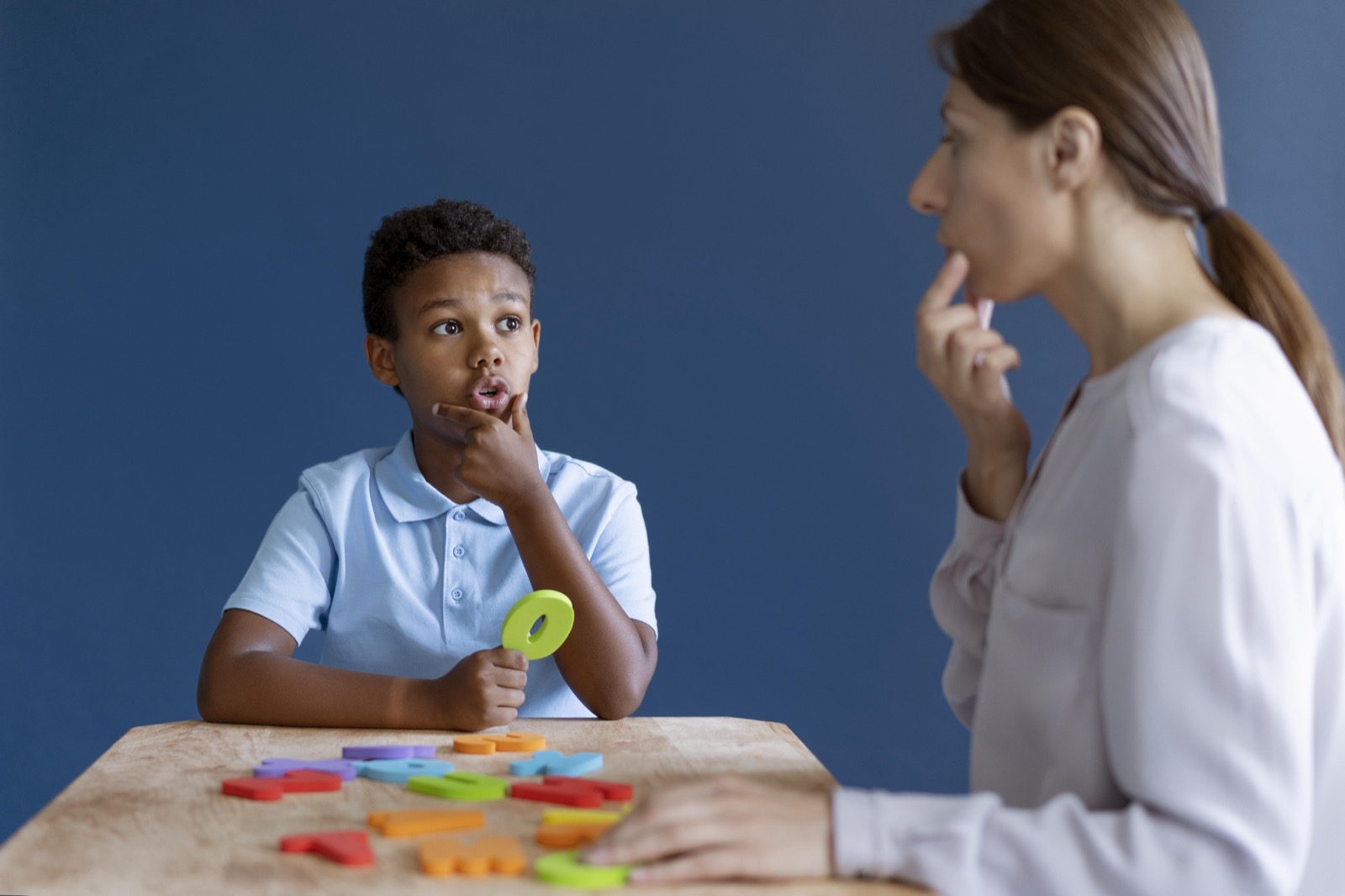 A boy having an occupational therapy session with a psychologist