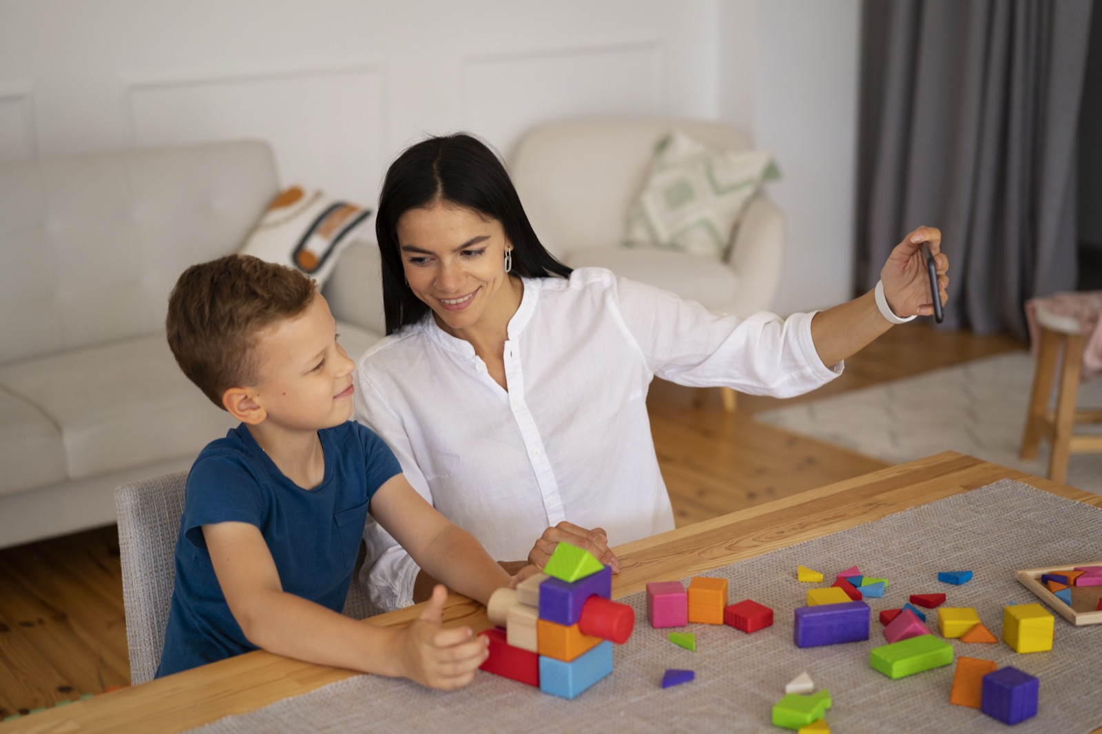 A child playing a brain teaser with their mom