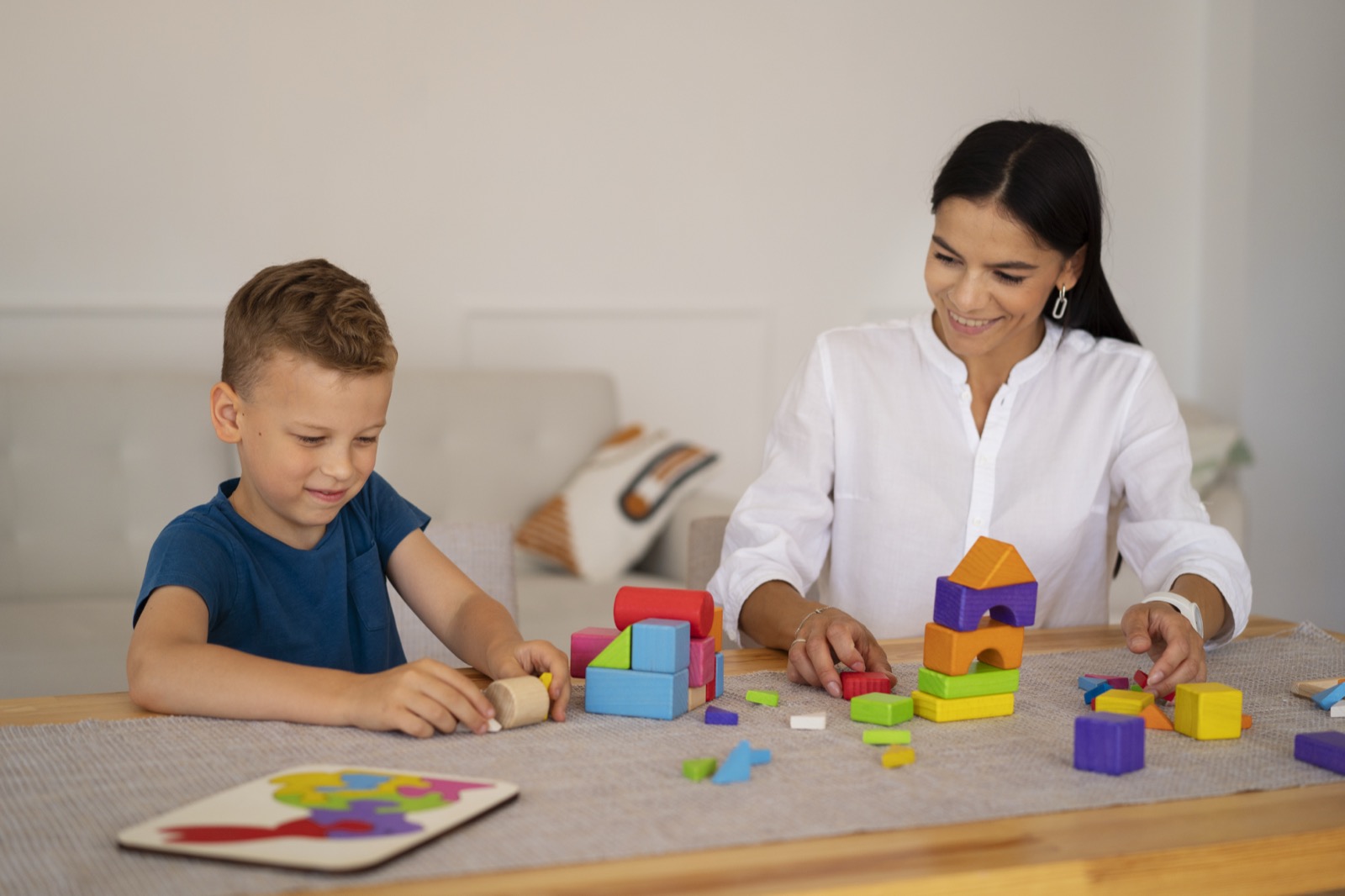 A child playing a brain teaser with their mom