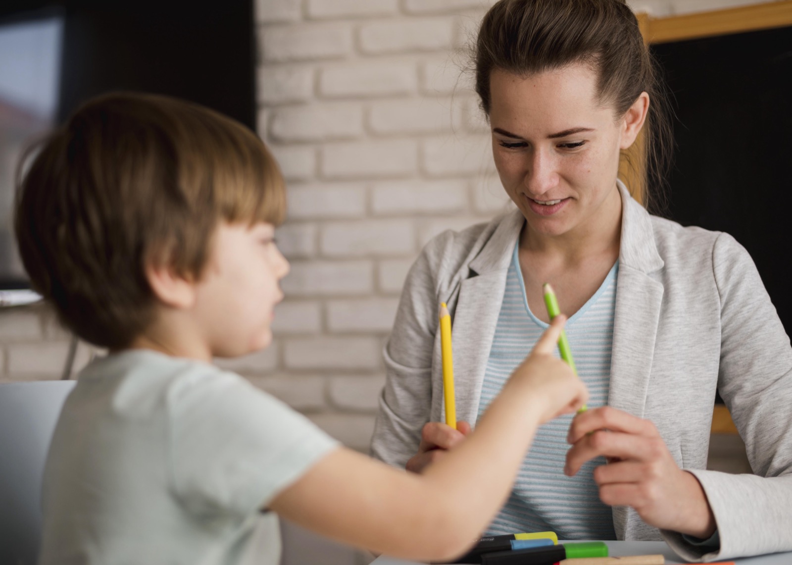 A tutor teaching a child how to count