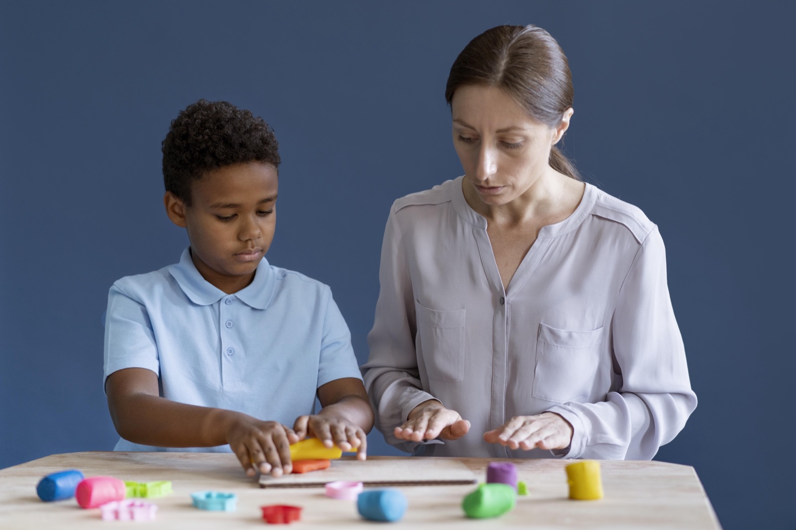 A child working with a psychologist during an occupational therapy session