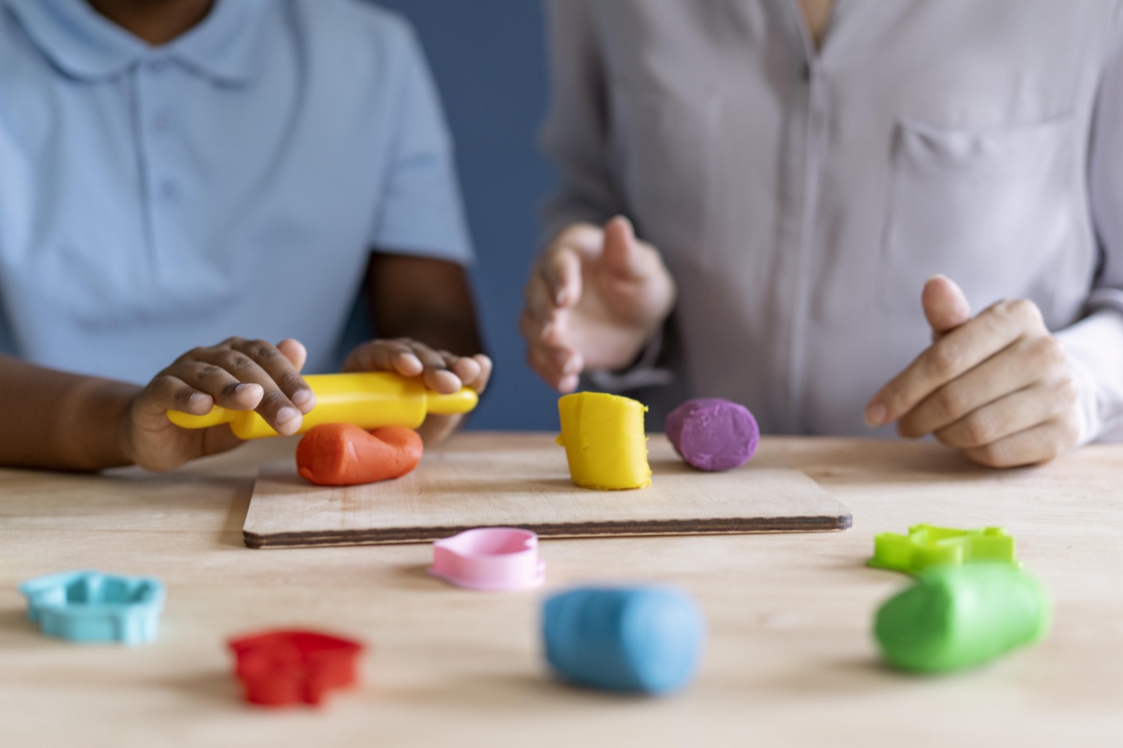 A child working with a psychologist during an occupational therapy session