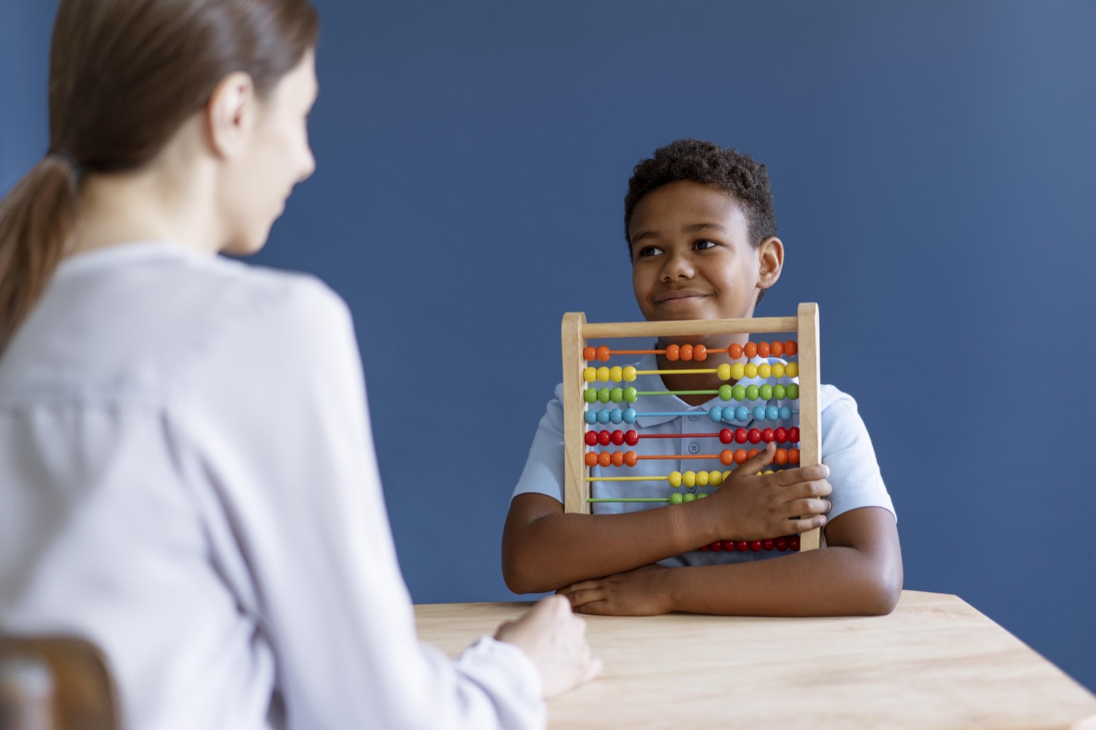 A young boy having an occupational therapy session with a psychologist