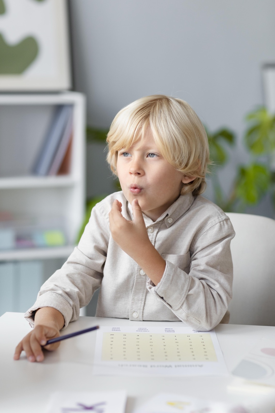 A young boy practicing speech therapy exercises