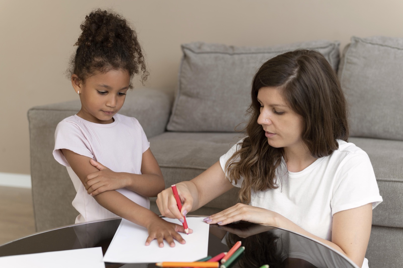 A mother and daughter drawing together