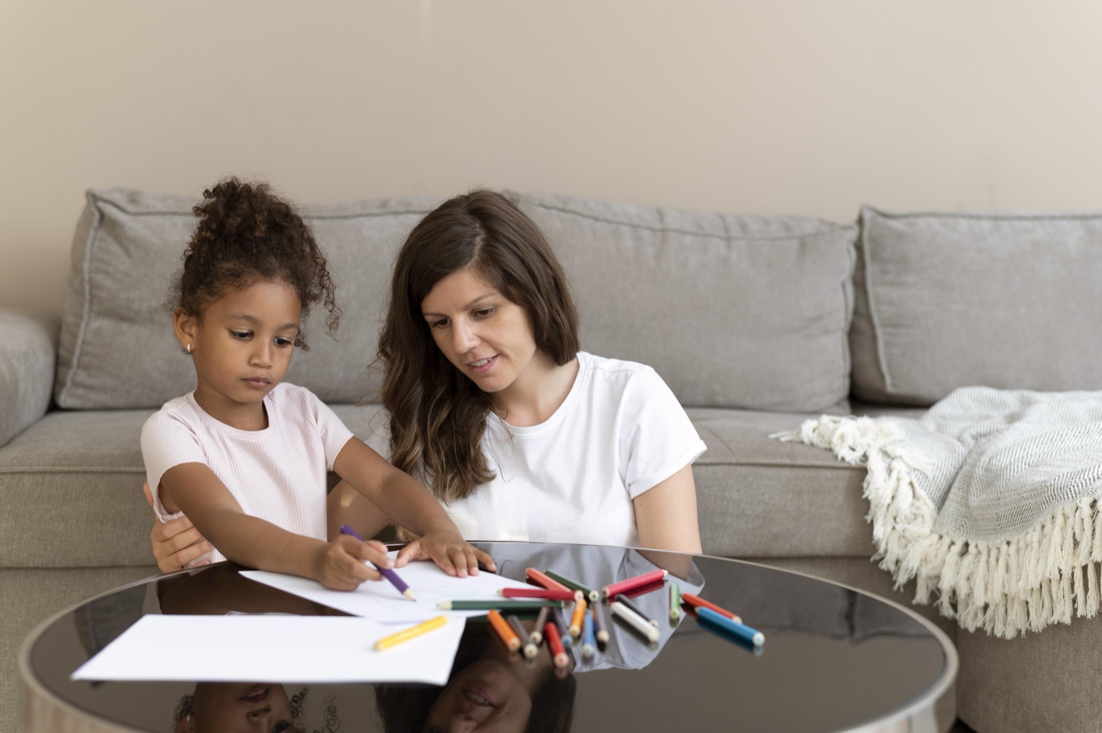 A mother and daughter drawing together