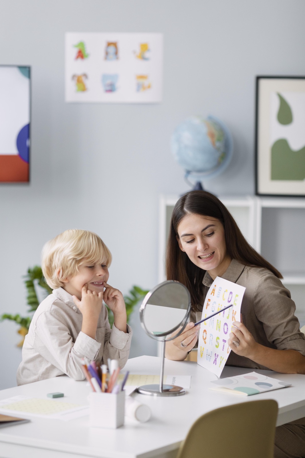 A therapist doing speech therapy with a boy at her clinic
