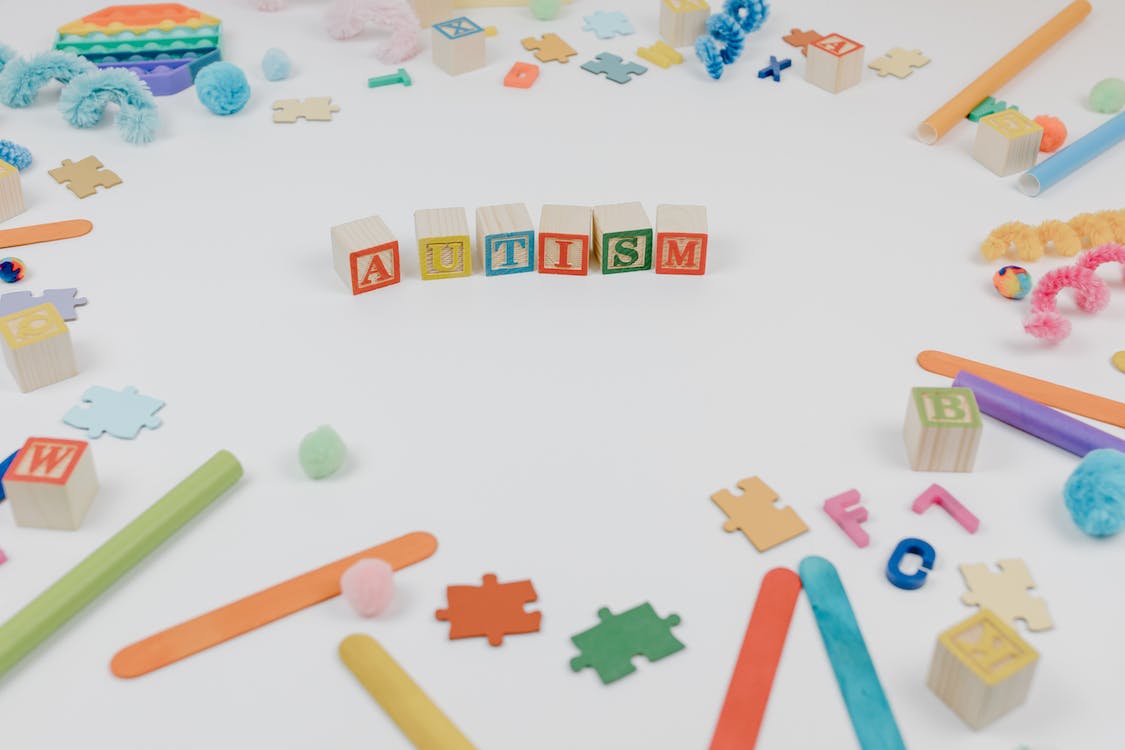 Free Autism spelled using Wooden Blocks on a White Surface Stock Photo