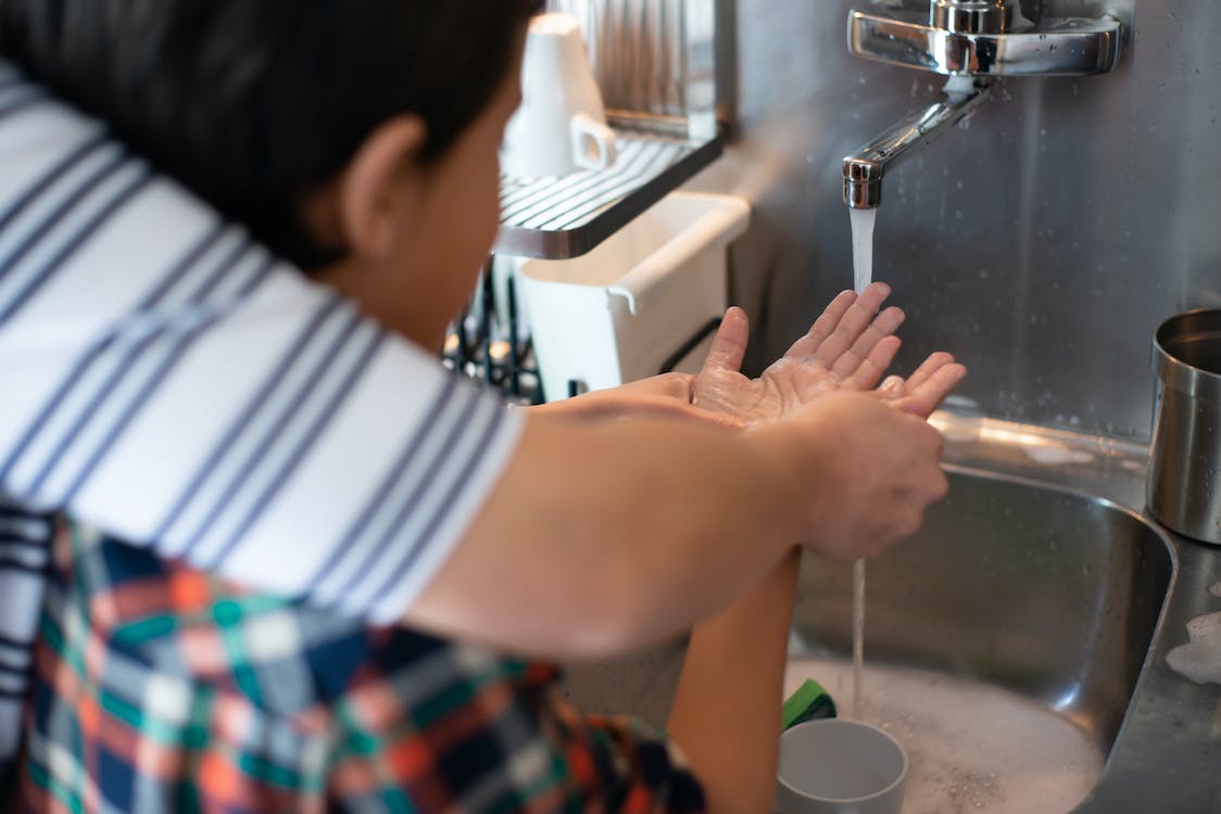 Free Teaching a Boy How to Wash his Hands Stock Photo