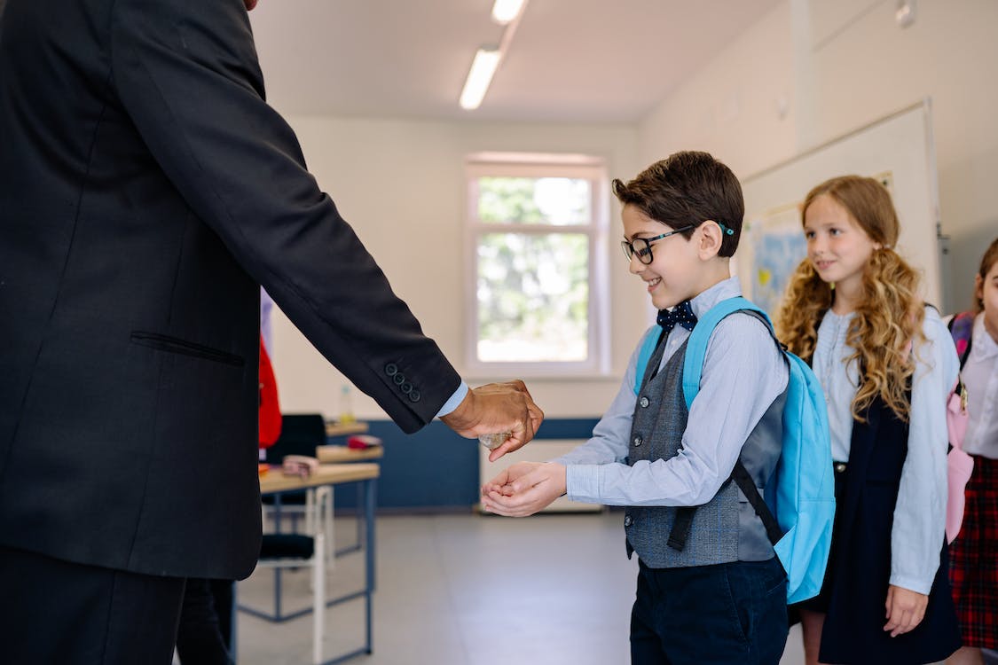 Free A Teacher Spraying Hand Sanitizer Stock Photo
